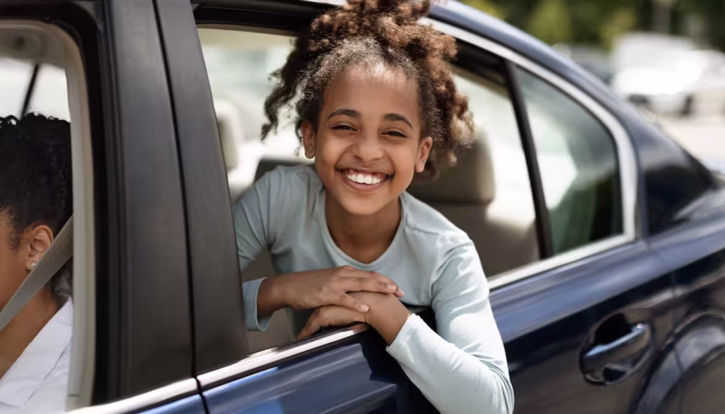 African American Child looking out of car window
